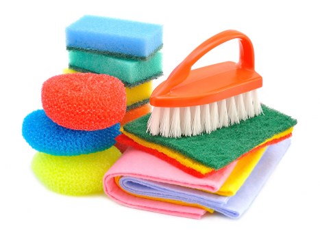 Cleaner using PPE while treating a carpeted area